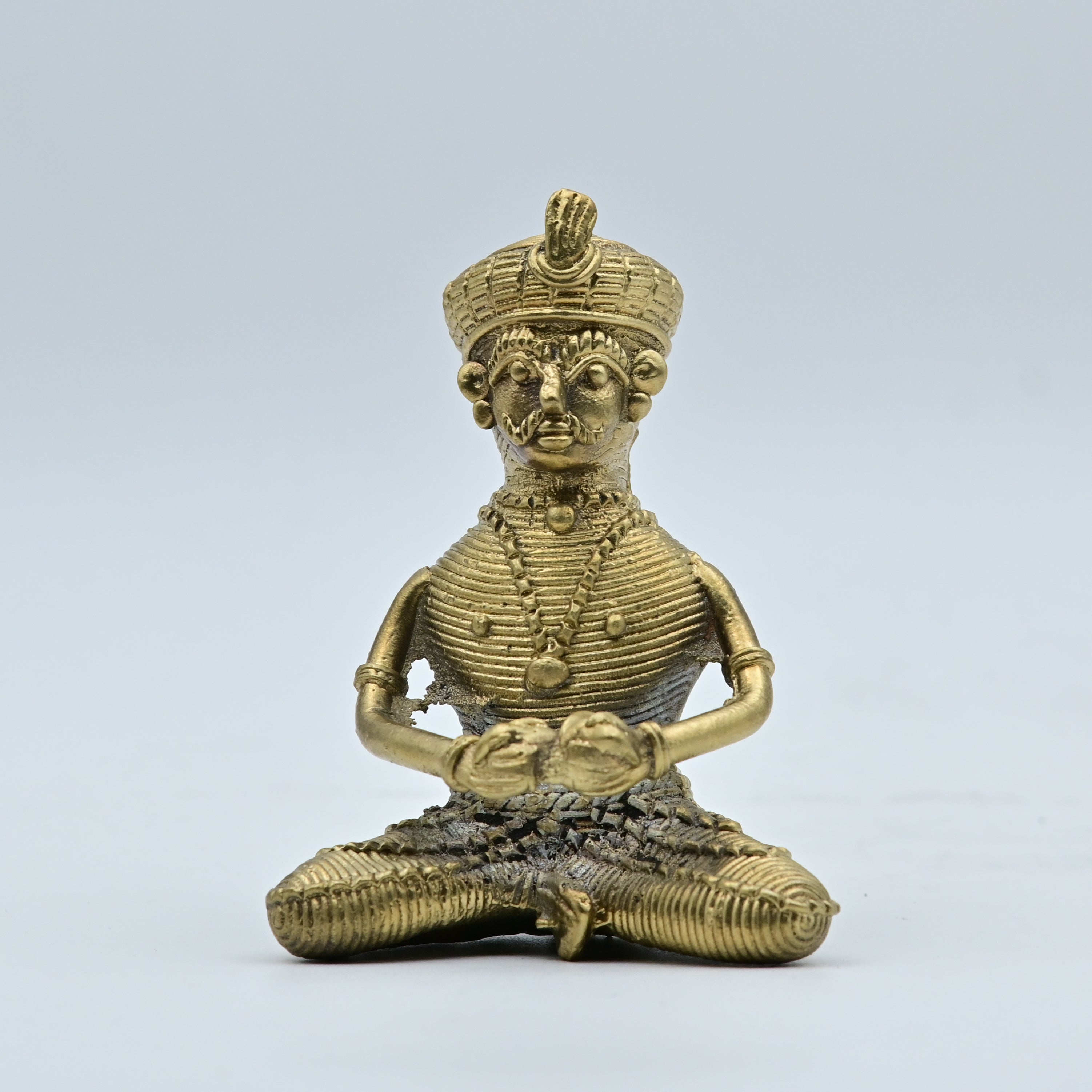 This is a handcrafted brass figurine created using the ancient Dhokra (or Dokra) lost-wax casting technique, a traditional art form primarily practiced by tribal communities in eastern India. 