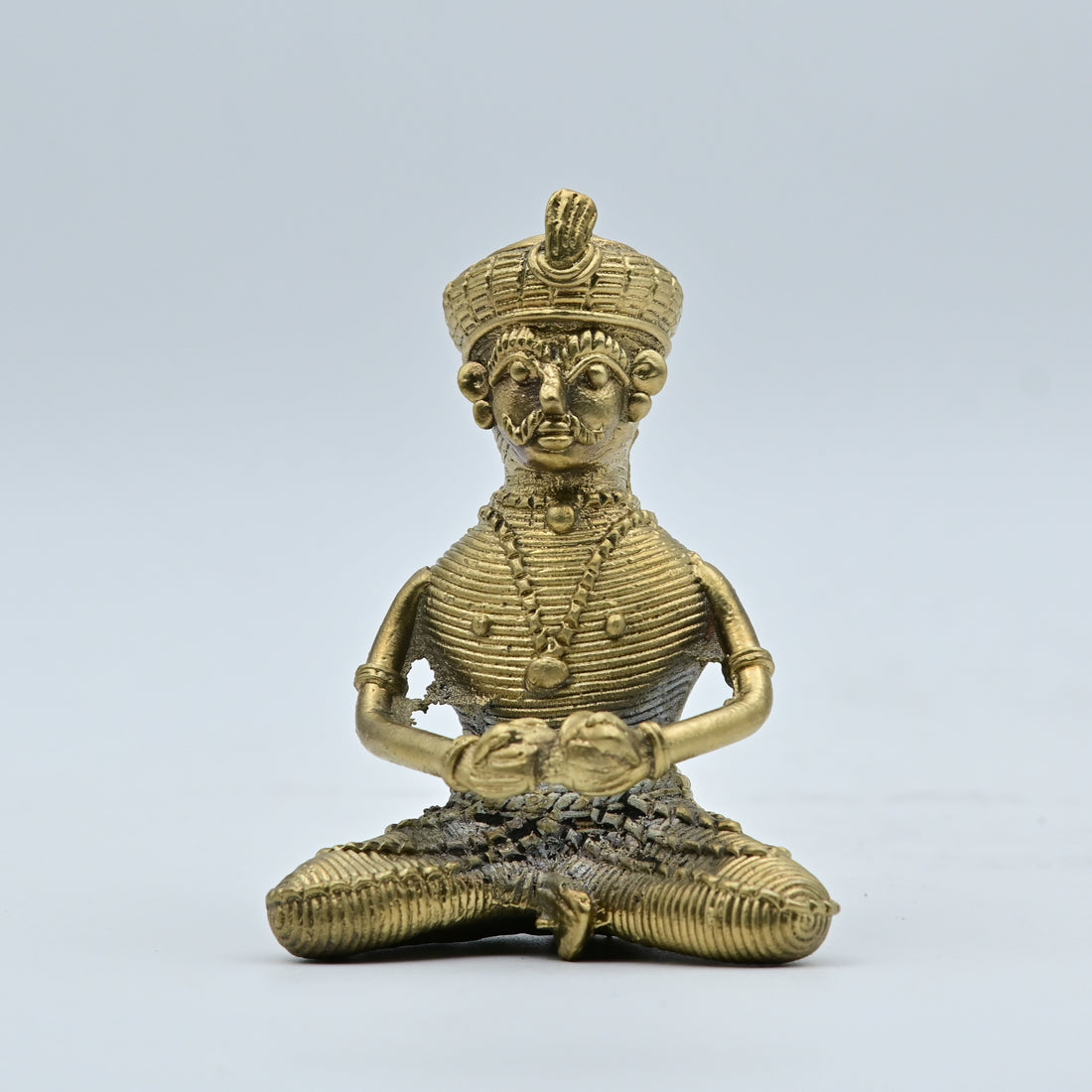 This is a handcrafted brass figurine created using the ancient Dhokra (or Dokra) lost-wax casting technique, a traditional art form primarily practiced by tribal communities in eastern India. 