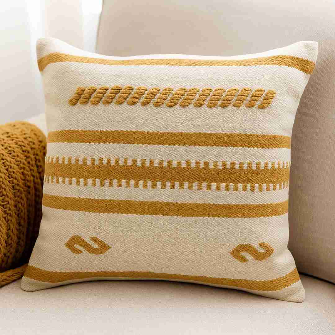 Decorative pillow with yellow stripes and patterns on a neutral background