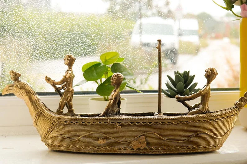 This item is a handcrafted brass Dhokra boat figurine, a traditional Indian art form. 