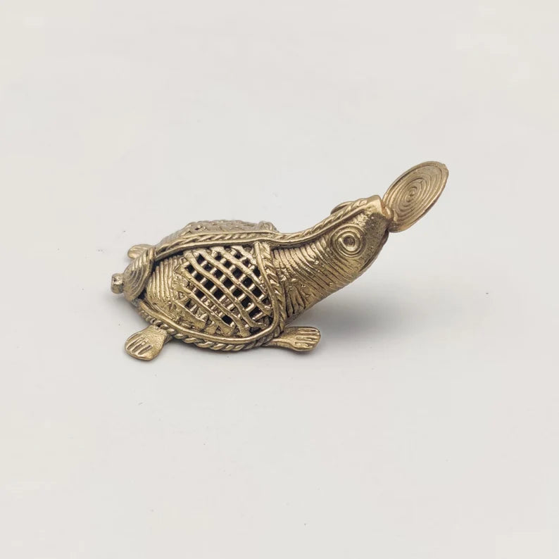 This item is a brass statue of a sea turtle created using the ancient Dhokra lost-wax casting technique, often used as a decorative showpiece or lucky charm. 