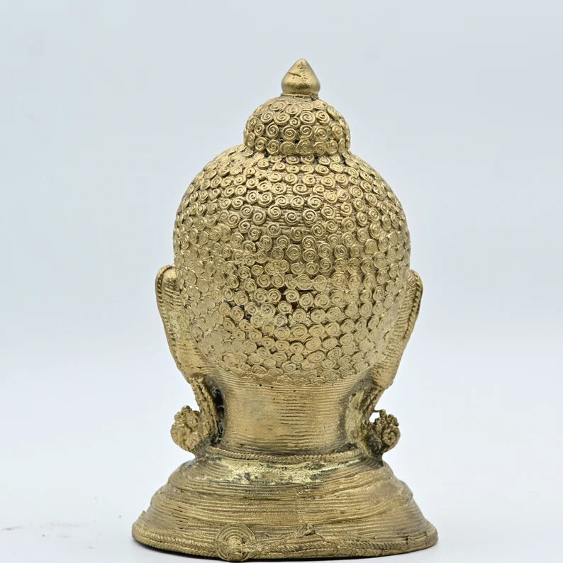 This is a handcrafted metallic brass sculpture of a Buddha head, commonly used as a decorative showpiece for homes and offices. 