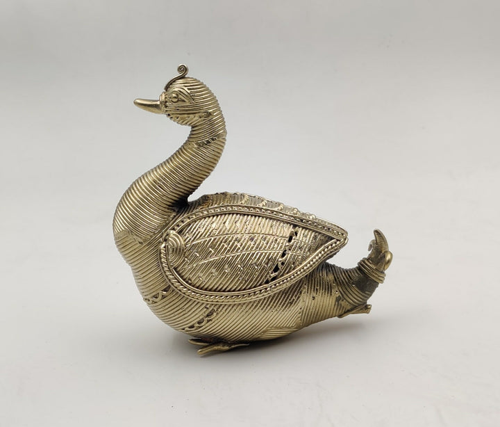 A Dhokra metal statue of an Indian swan with a gold hue.
