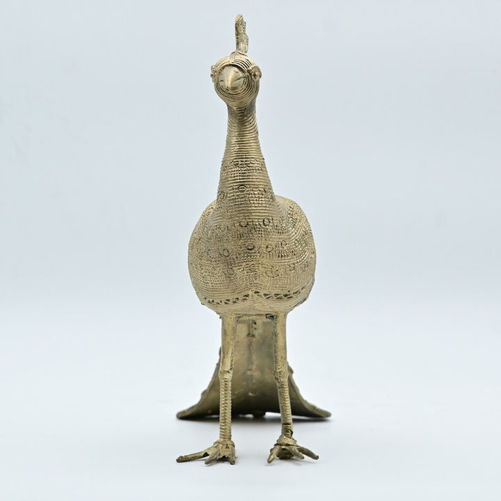 This item is a Dhokra metal peacock statue, a traditional form of Indian tribal art created using the lost-wax casting technique. 
