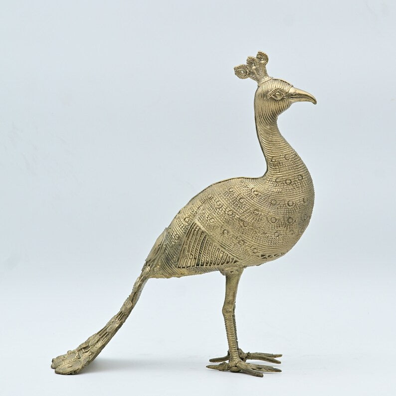This item is a handcrafted brass peacock statue, often created using the traditional Dhokra tribal art technique in India. 